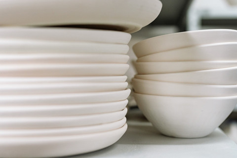 A stack of white plates and bowls.
