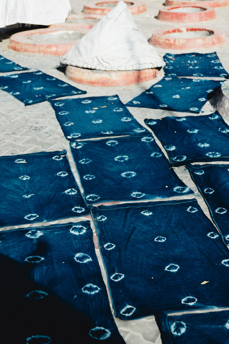 Squares of indigo-dyed cotton drying in the sun.
