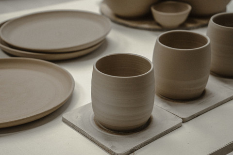 Matte stone-grey cups and plates.