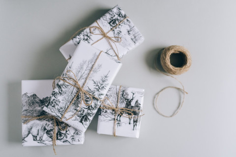 Gifts wrapped in printed paper and twine.