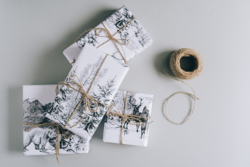 Gifts wrapped in printed paper and twine.