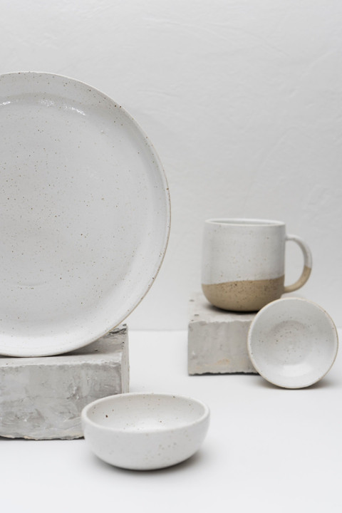A white stoneware bowl, plate and mug.