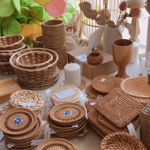 Rattan baskets and coasters on a table.