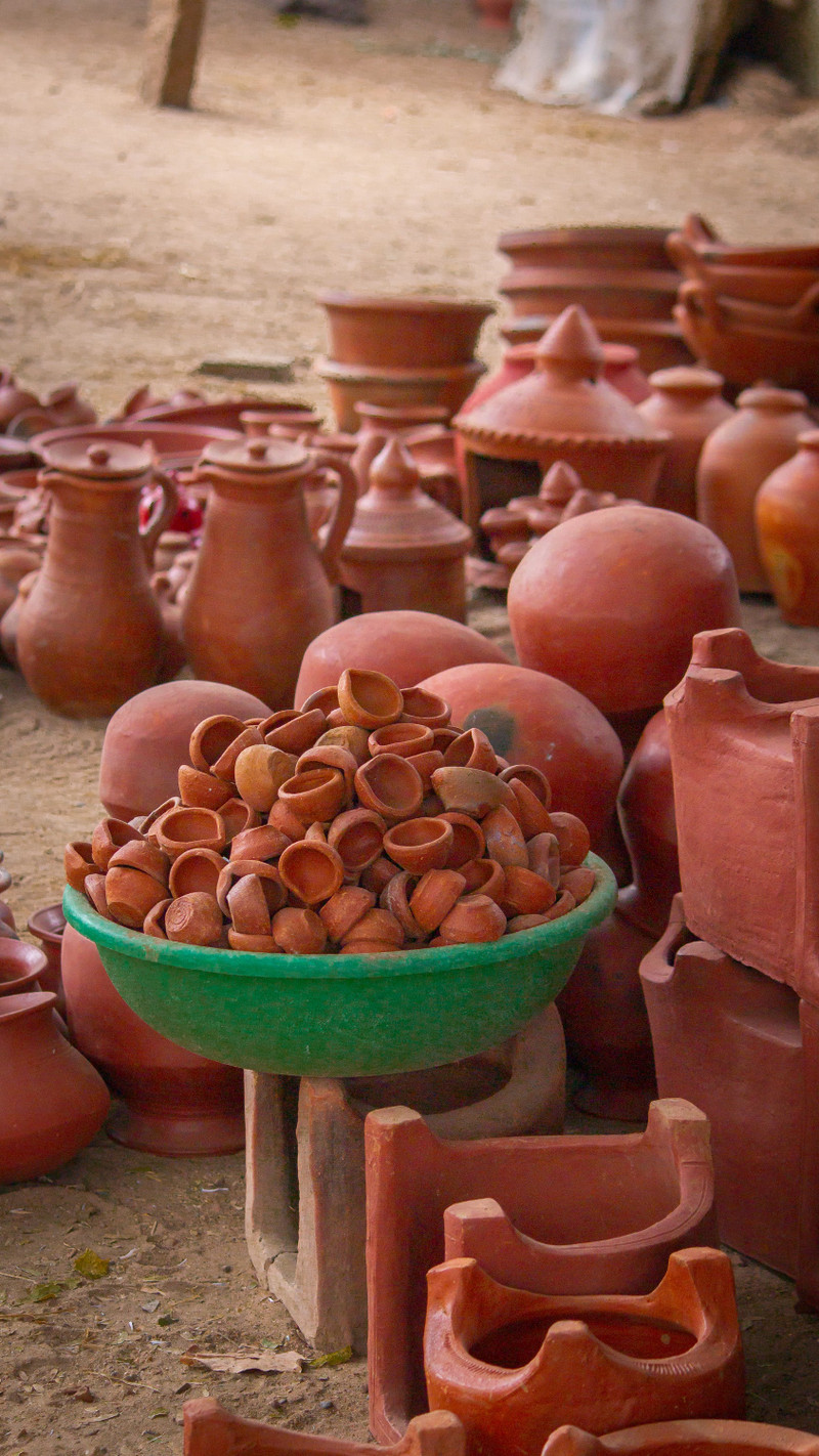 Handmade terracotta pots and planters at a market.