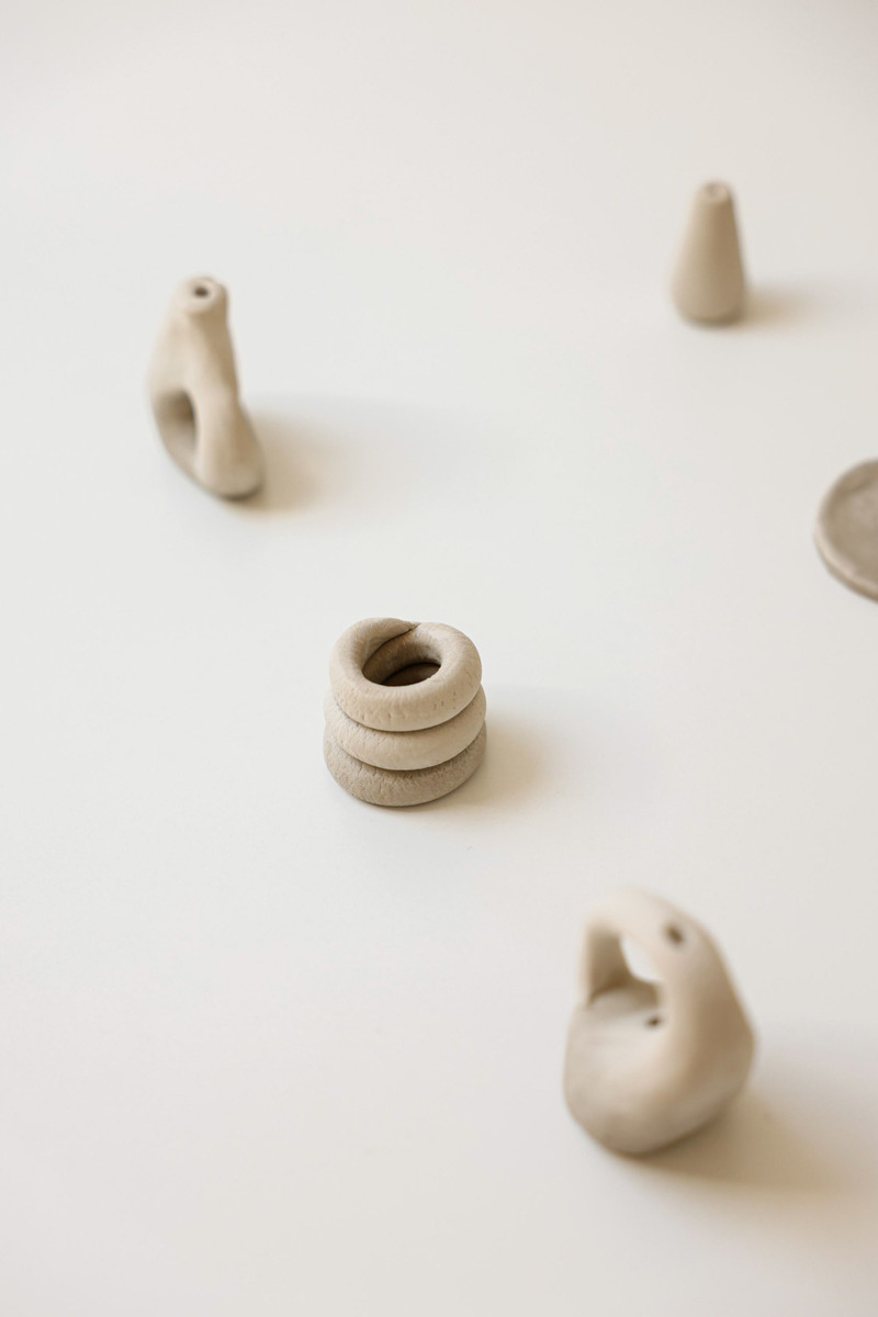 Clay incense holders with a sprig of eucalyptus.